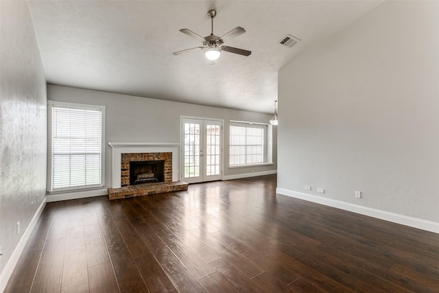 unfurnished living room with ceiling fan, a fireplace, and dark hardwood / wood-style flooring