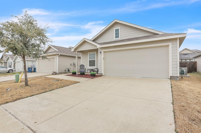 view of front of house with concrete driveway, a garage, and fence