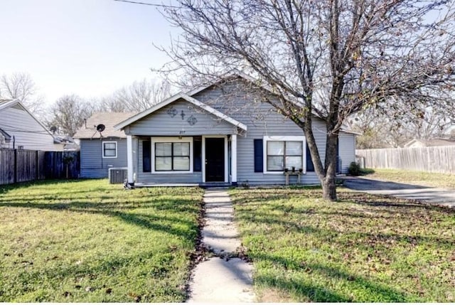 view of front of house featuring central AC unit and a front lawn