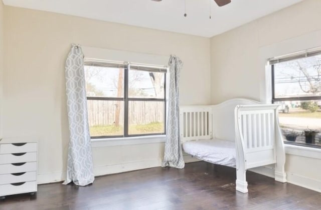 unfurnished bedroom featuring ceiling fan and dark hardwood / wood-style flooring