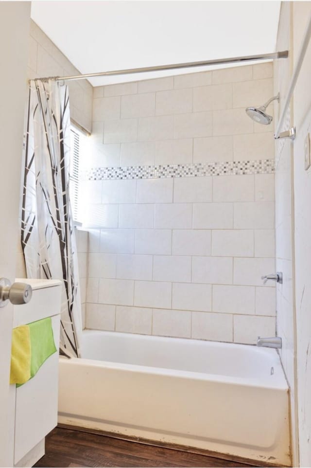 bathroom featuring hardwood / wood-style flooring and shower / bath combo