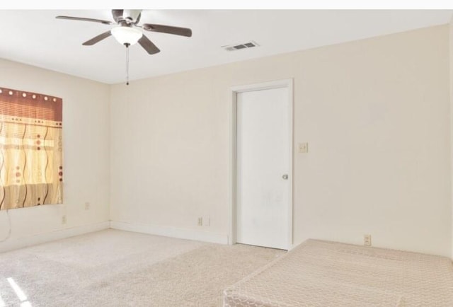 empty room with carpet floors and ceiling fan