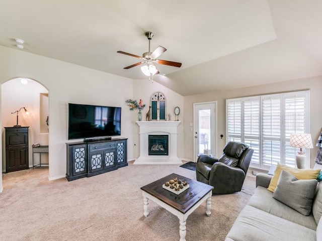 carpeted living room with vaulted ceiling and ceiling fan