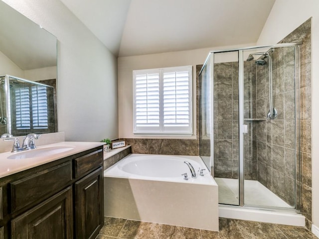 bathroom with lofted ceiling, vanity, and shower with separate bathtub