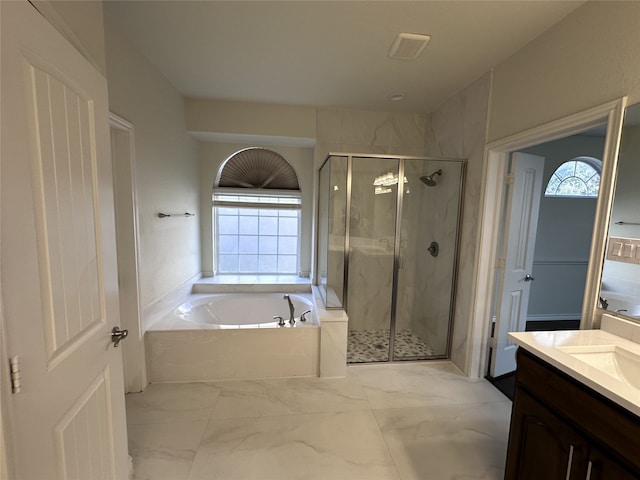 bathroom featuring vanity and shower with separate bathtub