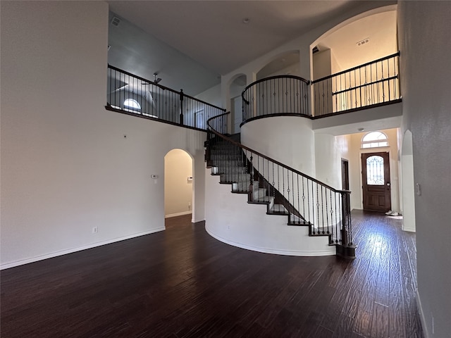 interior space featuring wood-type flooring and a high ceiling