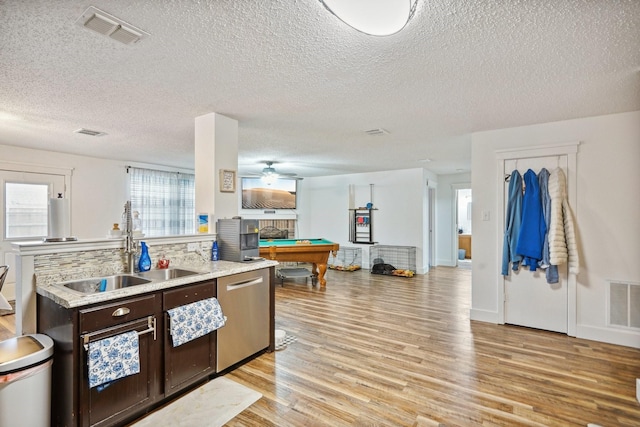 kitchen with billiards, dishwasher, sink, dark brown cabinetry, and light hardwood / wood-style flooring