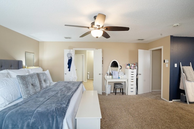 carpeted bedroom with ceiling fan and a textured ceiling