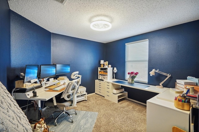 office area featuring light colored carpet and a textured ceiling