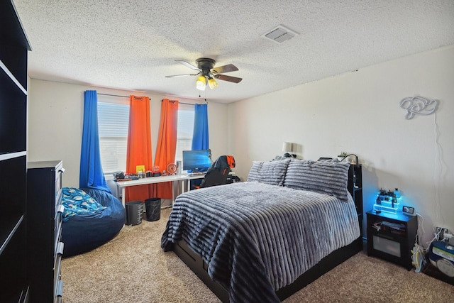 bedroom featuring carpet, a textured ceiling, and ceiling fan