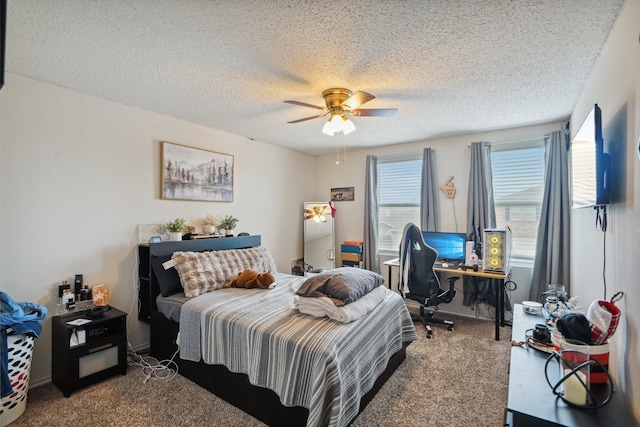 carpeted bedroom featuring ceiling fan and a textured ceiling