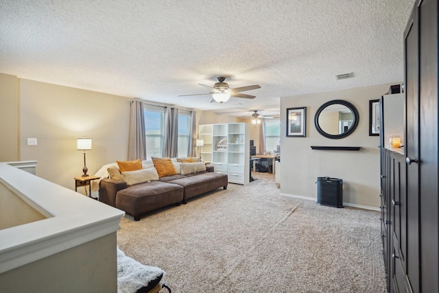 carpeted living room with plenty of natural light and a textured ceiling