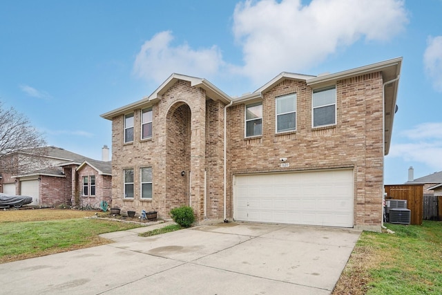 view of front of property with a garage, a front yard, and central air condition unit