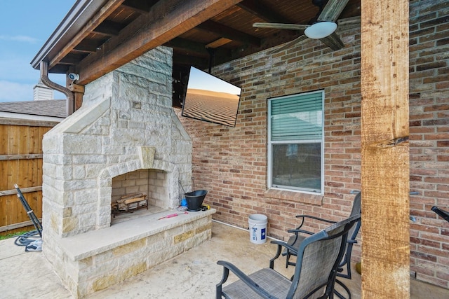 view of patio featuring ceiling fan and an outdoor stone fireplace