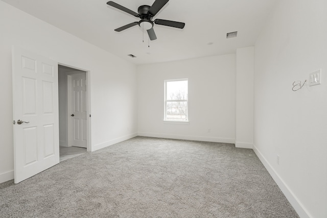 unfurnished room with ceiling fan and light colored carpet