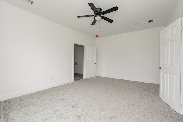 spare room with carpet and ceiling fan