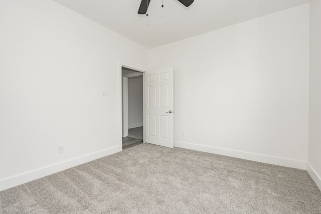 empty room featuring carpet floors and ceiling fan