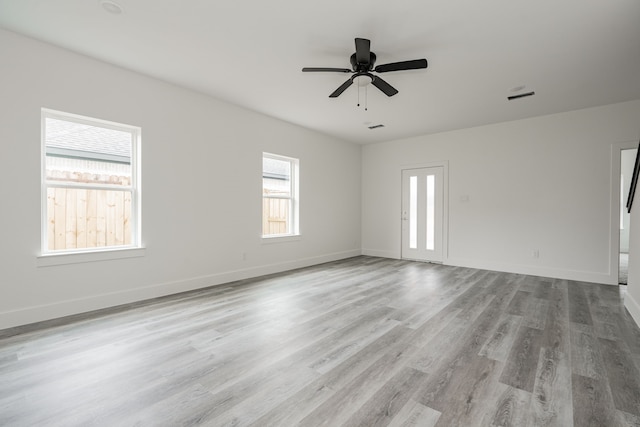 unfurnished room featuring light hardwood / wood-style floors and ceiling fan