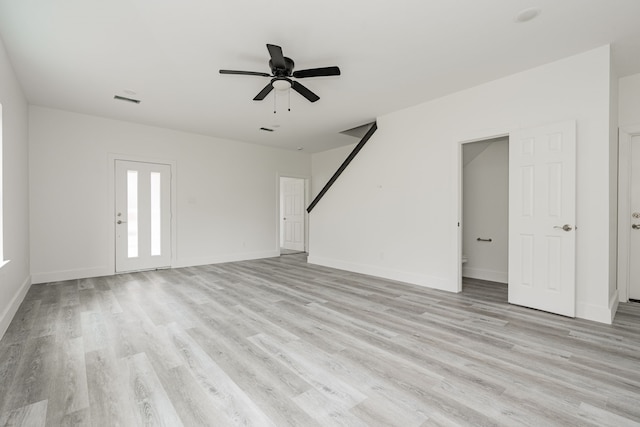 unfurnished living room featuring ceiling fan and light hardwood / wood-style flooring