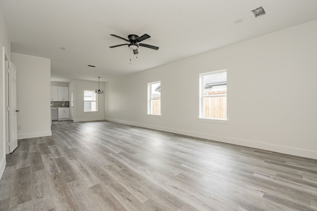 unfurnished living room featuring ceiling fan and light hardwood / wood-style floors