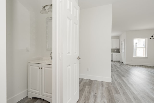 bathroom featuring vanity, wood-type flooring, and backsplash