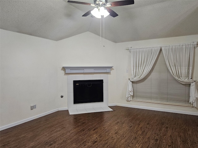 unfurnished living room with a tile fireplace, wood-type flooring, lofted ceiling, ceiling fan, and a textured ceiling