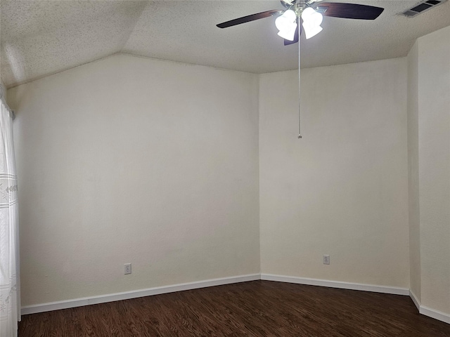 spare room featuring ceiling fan, lofted ceiling, dark hardwood / wood-style floors, and a textured ceiling