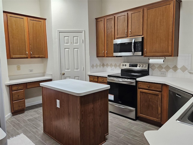 kitchen featuring a kitchen island, tasteful backsplash, and appliances with stainless steel finishes