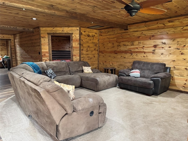 carpeted living room featuring wood ceiling, ceiling fan, and wood walls