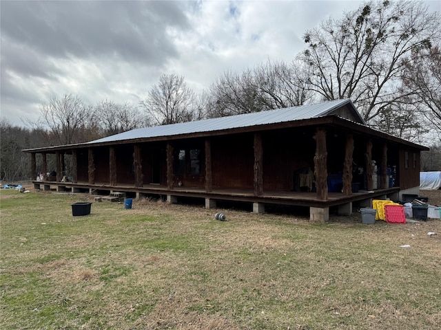 rear view of house featuring a lawn