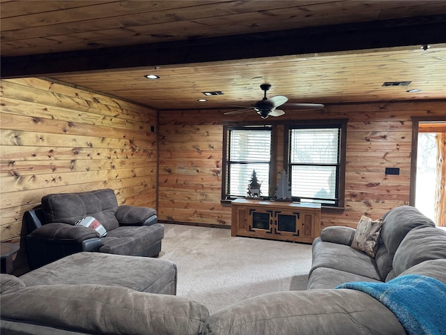 living room featuring beamed ceiling, a healthy amount of sunlight, light carpet, and wooden ceiling