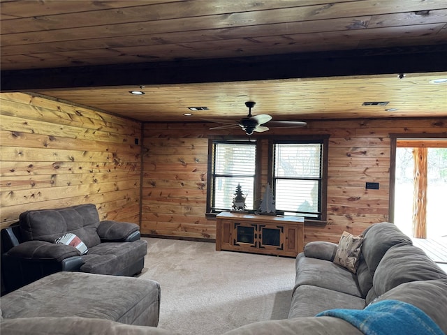 living room with beam ceiling, light colored carpet, and wood ceiling