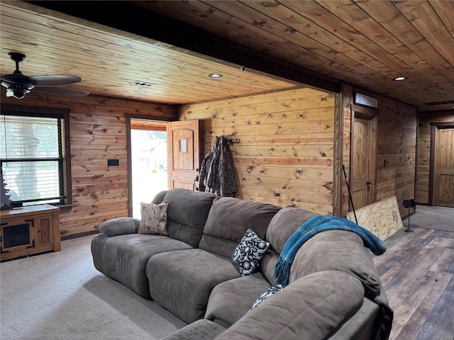 living room with wood ceiling, ceiling fan, and wooden walls