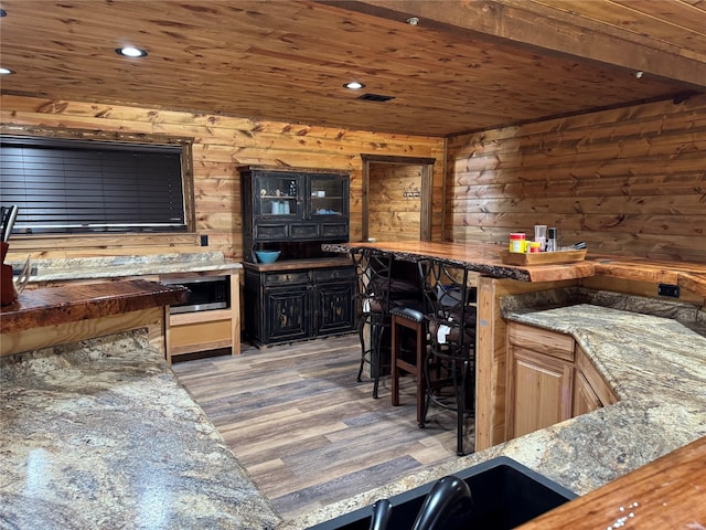 bar with wood ceiling and dark hardwood / wood-style flooring