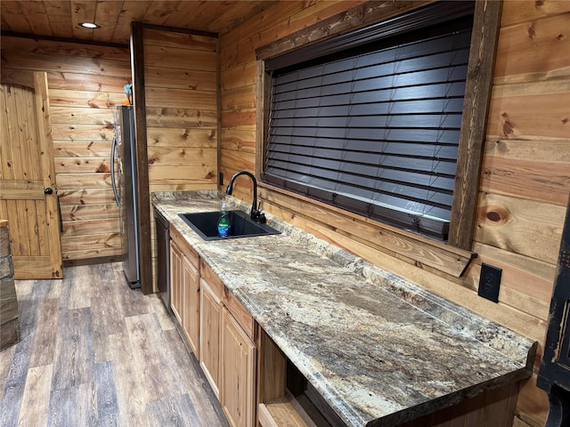 bathroom with hardwood / wood-style flooring, sink, wooden ceiling, and wooden walls