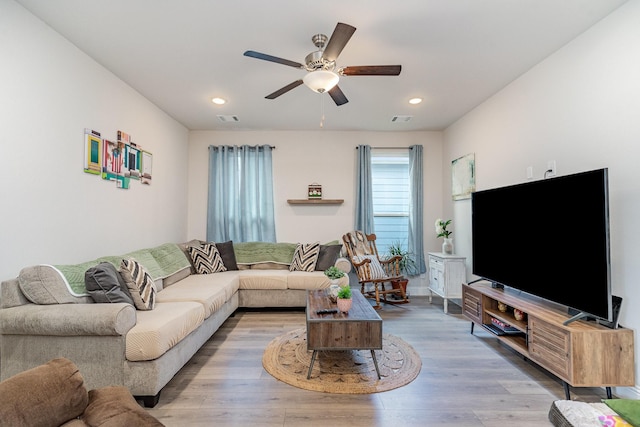 living room featuring ceiling fan and light wood-type flooring