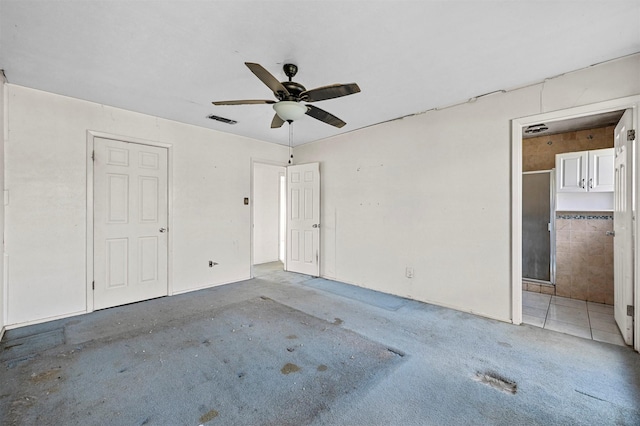 unfurnished bedroom with ceiling fan and ensuite bathroom