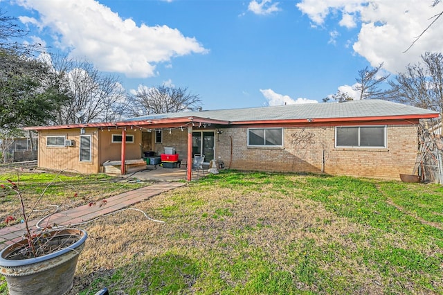 back of house with a patio and a lawn