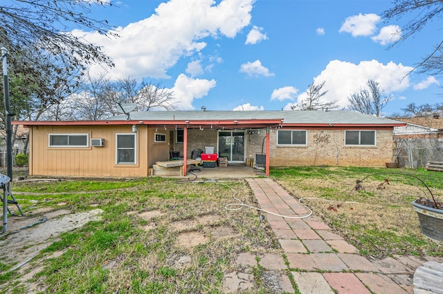 rear view of property featuring a patio area and a lawn