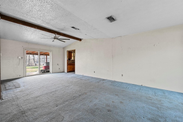 unfurnished room with vaulted ceiling with beams, ceiling fan, a textured ceiling, and carpet flooring