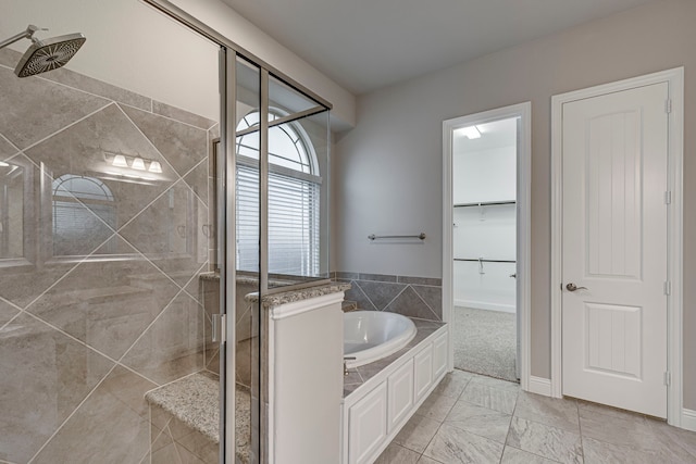 bathroom with shower with separate bathtub