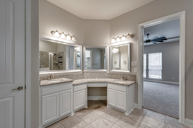 bathroom with ceiling fan, vanity, and a shower with door