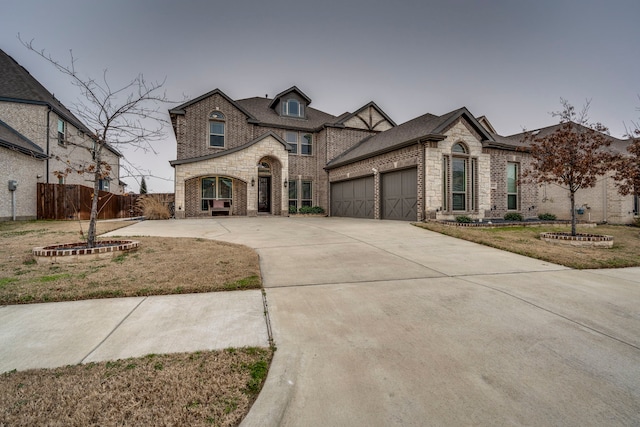 french provincial home featuring a garage and a front lawn