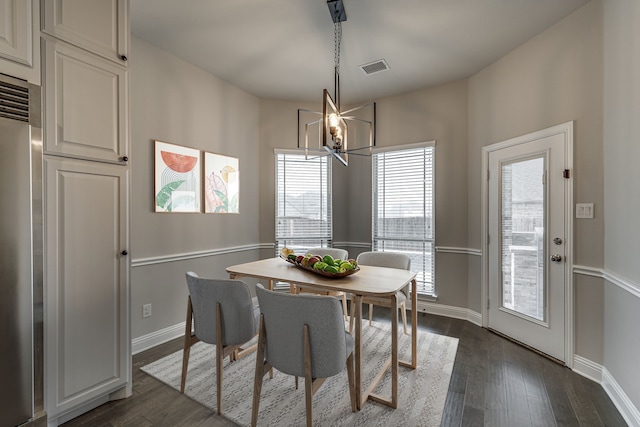 dining area featuring an inviting chandelier and dark hardwood / wood-style floors