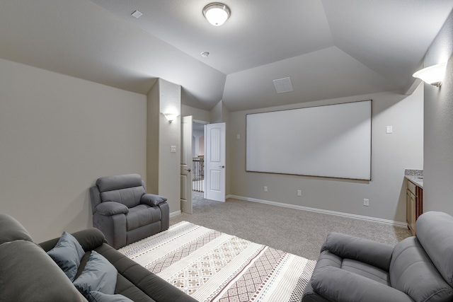 carpeted cinema with lofted ceiling