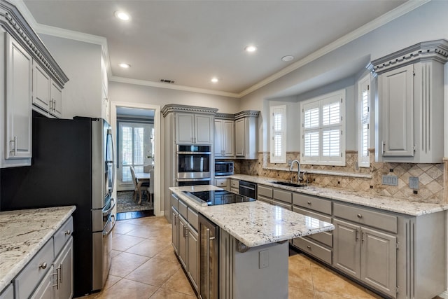 kitchen with gray cabinets, a center island, and stainless steel appliances