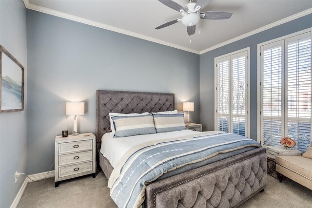 carpeted bedroom with ceiling fan and ornamental molding