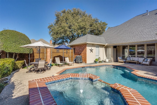 view of swimming pool with an in ground hot tub, pool water feature, an outdoor living space, and a patio area