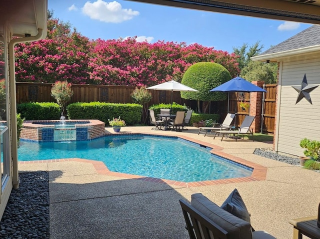 view of pool with an in ground hot tub and a patio