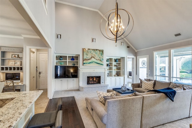 living room featuring crown molding, a fireplace, and built in features